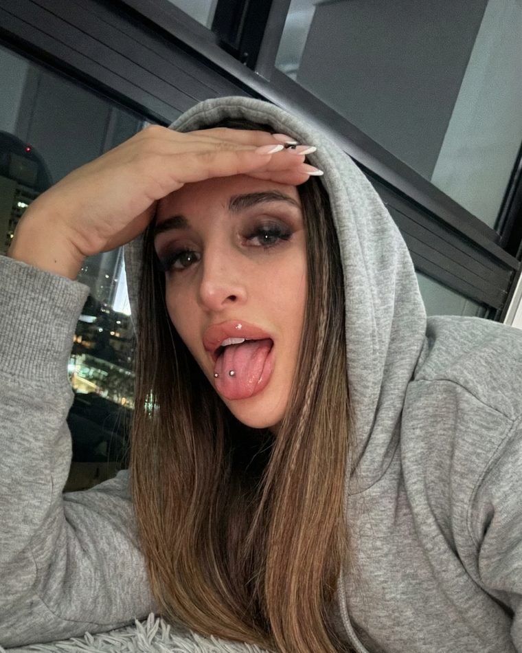 Lena in a hoodie smiling at the camera